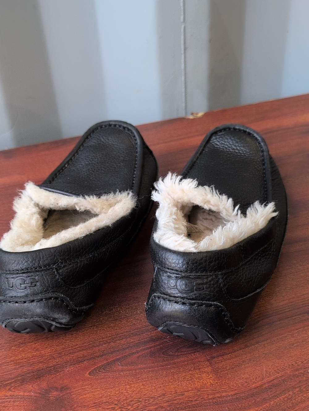 UGG (US-9) Black Leather Slip-Ons with Cream Shearling